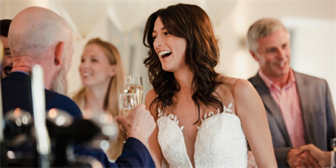 Smiling bride talking with guests
