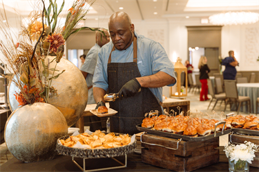 Proof of the Pudding Chef placing sliders on a plate
