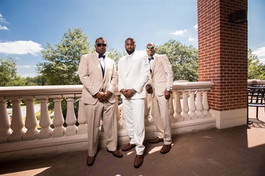 A groom with 2 groomsmen on the patio
