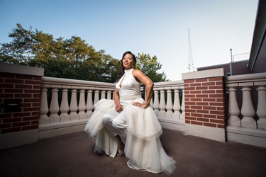 Bride seated in the corner of the patio railing